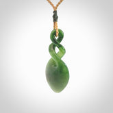 Hand carved New Zealand jade twist pendant. Carved in New Zealand by NZ Pacific. Unique double twist jewellery for sale online. Provided with an adjustable tan cord.